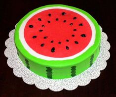 a watermelon cake is on a doily