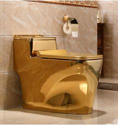 a gold toilet with the lid up in a bathroom area that has marble walls and flooring