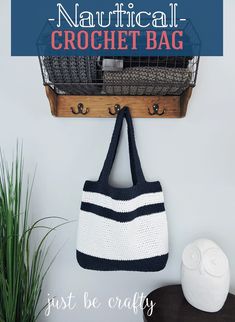 a crochet bag hanging on the wall next to a potted plant and basket