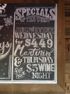 a chalkboard sign advertising specials for wine