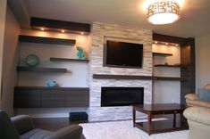 a living room with a fireplace and entertainment center