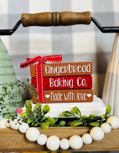 a wooden sign that says gingerbread baking co and made with love sitting on a table