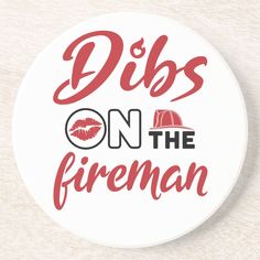 a white button with the words dibs on the fireman written in red ink