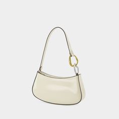 The Ollie hobo bag by Staud showcases a sleek, curved silhouette crafted from smooth leather with contrasting trim. A unique handle with gold and silver-tone rings introduces a playful element, and the spacious interior ensures that essentials are well-organized.

- Material: Smooth leather
- Handle: Unique design with gold and silver-tone rings
- Interior: Spacious for easy organization
- Style: Sleek, curved silhouette
- Trim: Contrasting details Luxury Everyday Baguette Bag With Handles, Elegant Everyday Baguette Bag With Round Handle, Daily Use Baguette Bag With Gold-tone Hardware, Elegant Baguette Bag With Detachable Strap And Round Handle, Chic Formal Baguette Bag With Round Handle, Chic Rectangular Baguette Bag For Daily Use, Chic Rectangular Baguette Bag For Everyday, Elegant Everyday Shoulder Bag With Round Handle, Chic Formal Baguette Bag With Metal Hardware