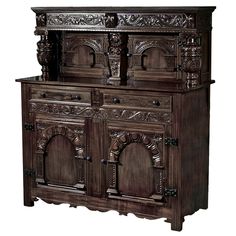 an old fashioned wooden cabinet with carvings on the front and side panels, in dark wood