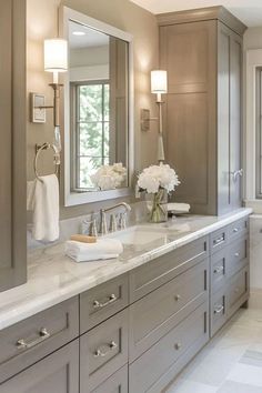 a large bathroom with two sinks and mirrors