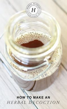 a jar filled with liquid sitting on top of a wooden table