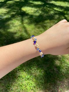 Meet our handmade Daisy Flower Bracelet in blue ombre, with an elegant gold finish. It makes a great gift for many occasions such as birthdays, anniversaries, Christmas and more! Silver finish is also available in our shop. It is an adjustable bracelet from 6 inch to 7.5 inches in length which should fit most people comfortably. If you are looking for a specific length, please message us as we would love to make it for you! This fully handmade floral-themed bracelet features intricate designs us Blue Flower Shaped Beaded Bracelet For Gift, Blue Resizable Bangle Jewelry, Blue Dainty Beaded Bracelets For Friendship, Gold Flower Beaded Bracelets For Party, Dainty Blue Beaded Bracelets For Friendship, Handmade Blue Flower Bracelets, Gold Floral Beaded Bracelets For Parties, Gold Flower-shaped Beaded Bracelets For Parties, Dainty Blue Crystal Bracelet For Gift