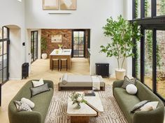 a living room filled with furniture and lots of windows