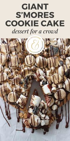 a cake with chocolate drizzle and marshmallows on top is shown in front of the words, giant s'more cookie cake dessert for a crowd