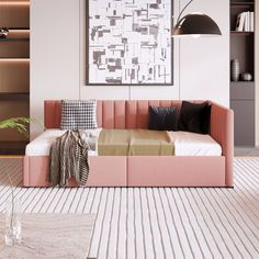 a living room with a pink couch and white rugs on the floor next to bookshelves