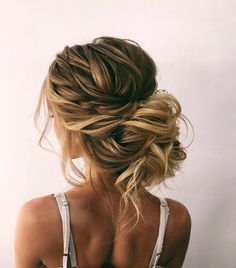 a woman with blonde hair in a low bun