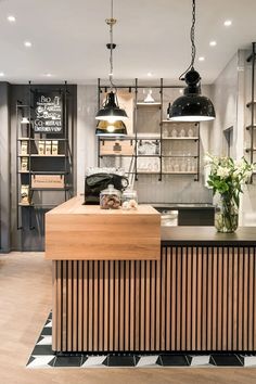 a kitchen with wooden counter tops and hanging lights