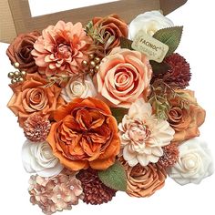 an arrangement of flowers in a cardboard box