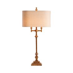 a table lamp with a white shade on it's base and a gold finish