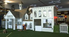 there is a fake doll house on display in the store's showroom area