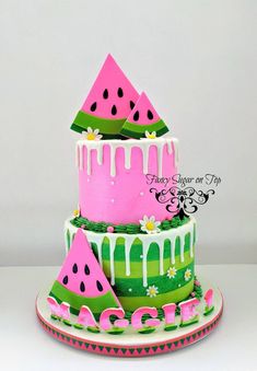 a three tiered cake with watermelon slices on it