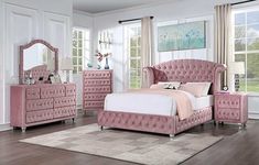 a bedroom with pink furniture and white walls