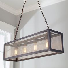 a light fixture hanging from the ceiling with three lights on it and two bulbs in them