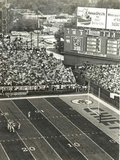 an old black and white photo of a football game in progress with the crowd watching