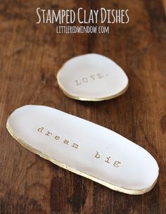 two white ceramic spoons sitting on top of a wooden table