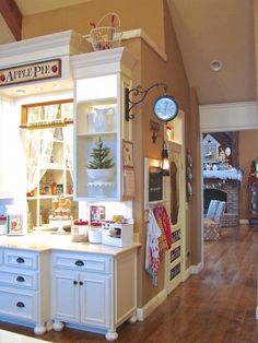 the kitchen is decorated in white and has lots of cupboards on top of it