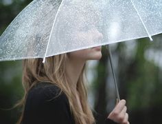 a woman holding an umbrella in the rain