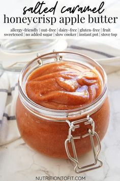 an apple butter in a glass jar on a marble counter top with text overlay that reads salted caramel honeycris apple butter