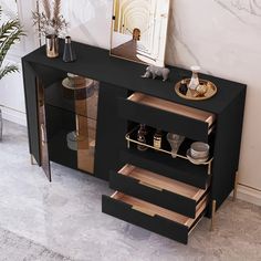 a black and gold sideboard in a living room next to a potted plant