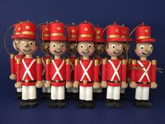 a group of wooden toy soldiers standing next to each other on a blue background,