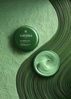 a bottle of flufferia cream sitting on top of a green wavy wall next to a jar of toothpaste