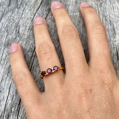 Three gorgeous little faceted garnet gemstones flanked with two tiny diamonds besides the middle one and set in gold vermeil. The open band is adjustable allowing it to be sized up a size. Diamond Ring Gold, Red Stone Ring, Signature Necklace, Shell Ring, Tiny Diamond, Garnet Ring, Plated Ring, Gold Plated Rings, Garnet Rings