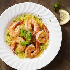 a white plate topped with shrimp and rice