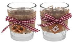 two glass cups with gingerbread cookies tied to each other and decorated with burlocks