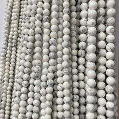 white marble beads are arranged in rows