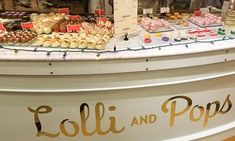 a display in a store filled with lots of different types of pastries and desserts