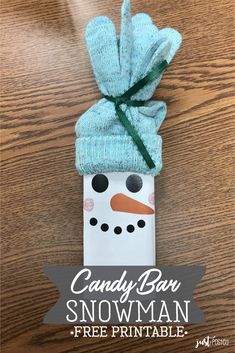 a paper bag with a snowman on it and the title candy bar snowman free printable