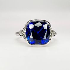 a ring with a blue stone surrounded by diamonds