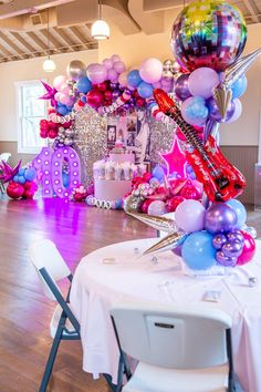 a table with balloons and musical instruments on it