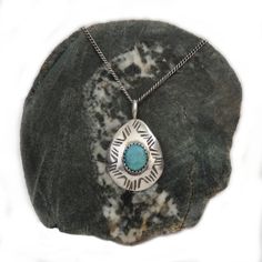 Vintage Native American/Navajo/Diné turquoise pendant handmade by artisan Tommy Singer. For over 50 years, Singer (born 1940, died 2013) was a world famous Navajo silversmith, trained from the age of 7 by his father, a Navajo Medicine man. This piece is a stunning bezel-set turquoise cabochon (possibly Kingman as that was a stone Singer used in much of his work), surrounded by hand-stamping on a teardrop-shape pendant. 18" sterling cable chain. Marked with the Tommy Singer T swirl signature plus Sterling. Tests measure silver level at 94.9. Pendant measures 1 1/4" total length x 3/4" wide. Weighs 3.62g. All measurements approximate. Estate auction find. Good vintage condition. Reasonable offers considered. 👉🏻To continue browsing in the shop please click this link: https://www.etsy.com/sh Medicine Man, Turquoise Pendant Necklace, Turquoise Pendant, World Famous, Silver Turquoise, Turquoise Sterling Silver, Cable Chain, 50 Years, Hand Stamped