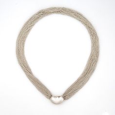 Stylish vintage Tiffany & Co multi-strand bean necklace, crafted in sterling silver (circa 1970s to 1980s).    The bean clasp is a classic design by Elsa Peretti and is a great example of her early work for Tiffany & Co. A total of 50 stands of sterling silver form together, allowing for movement and designed to meld to your neck. Soft and silky to the touch, the 15 inch choker length sits nicely at the nape of the neck.    The necklace is in very good original condition and was lightly cleaned and polished.    Particulars:    Weight: 49 grams    Stones: N/A.    Size & Measurements: The necklace measures 15 inches in length. The bean clasp measures 21mm x 12mm (0.82 x 0.47 inches).    Metal & Hallmark: Sterling silver. The necklace is hallmarked "Tiffany & Co", "Peretti" and "Sterling" Tiffany And Co Bean Necklace, Classic Silver Multi-strand Necklace, Elsa Peretti Necklace, Tiffany And Co Necklace Hardwear, Tiffany Elsa Peretti Bracelet, Bean Necklace, Vintage Multi-strand Silver Chain Necklace, Tiffany Elsa Peretti Necklace, Vintage Silver Multi-strand Chain Necklace