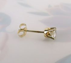 "This listing is for 1 (SINGLE) Vintage diamond 14k yellow gold stud post earring. It is perfect for the person who wears only one earring on one side or has multiple piercings on their ear or ears. A certified gemologist verbally verified the diamond as genuine and graded it with an SI2 (si2) clarity and I-J color. The 3.70mm round brilliant-cut gem has an approximate weight of .20 carat. It has a nice sparkle to it and four sturdy prongs hold it tightly in the 14k yellow gold crown style setti 14k Yellow Gold Solitaire Earrings, Gold Solitaire Diamond Earrings Fine Jewelry, Gold Solitaire Diamond Earrings, Gold Solitaire Diamond Earrings For Anniversary, Gold Solitaire Round Earrings, Diamond White Solitaire Diamond Earrings In 14k Gold, 14k Gold Solitaire Diamond White Diamond Earrings, Diamond White Solitaire Earrings In 14k Gold, 14k Yellow Gold Solitaire Diamond Earrings