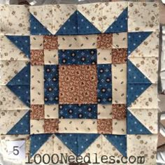 a blue and white quilted wall hanging