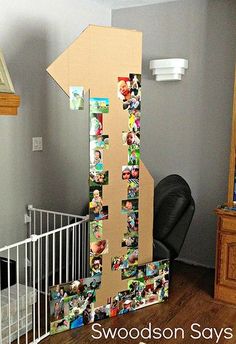 a cardboard arrow with pictures on it in a child's room next to a crib