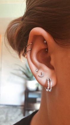 a close up of a person with ear piercings on their left and right ears