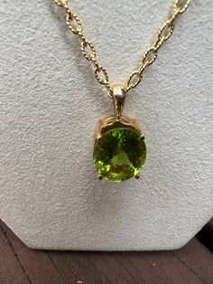 This stunning pendant exudes luxury with its 14kt yellow gold setting and Oval Green Peridot stone. Crafted with elegance and sophistication, this timeless piece is one to add to your collection. -14kt Yellow Gold Pendant-Oval Green Peridot StoneChain Details-14kt Yellow Gold Rolo Chain-16 inches Luxury Handmade Peridot Jewelry, Luxury Gold Peridot Necklaces, Luxury Yellow Gold Peridot Necklace, Luxury Oval Necklace With Stones, Peridot Necklace, Gold Rings Fashion, Peridot Stone, Rings Fashion, Spring Color