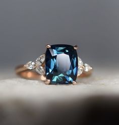 a blue diamond ring with two diamonds on it