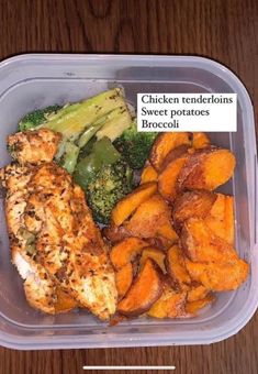 a plastic container filled with chicken, sweet potatoes and broccoli on top of a wooden table