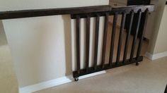 an empty room with white walls and a black railing on the floor in front of it