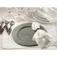 a table setting with silverware and napkins